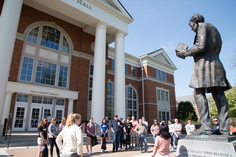 Large group of students Campus tour in front of Crounse Hall looking at Abraham Lincoln statue