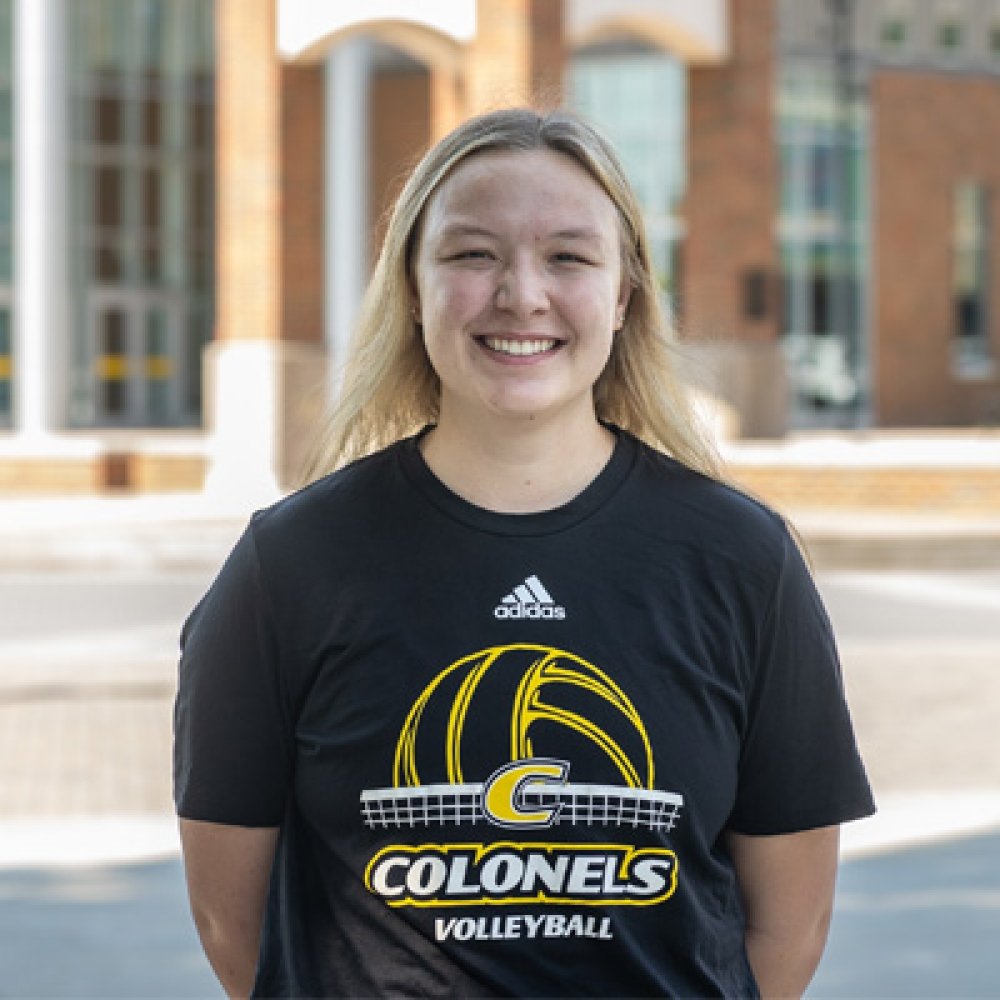 Person wearing Centre Colonels Volleyball tshirt and smiling at camera