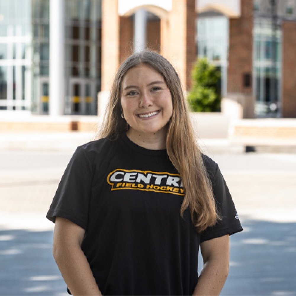 Person wearing Centre Field Hockey t shirt and smiling at camera
