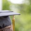 The photo of a grad cap with the tassel and 25 charm hanging off the side.