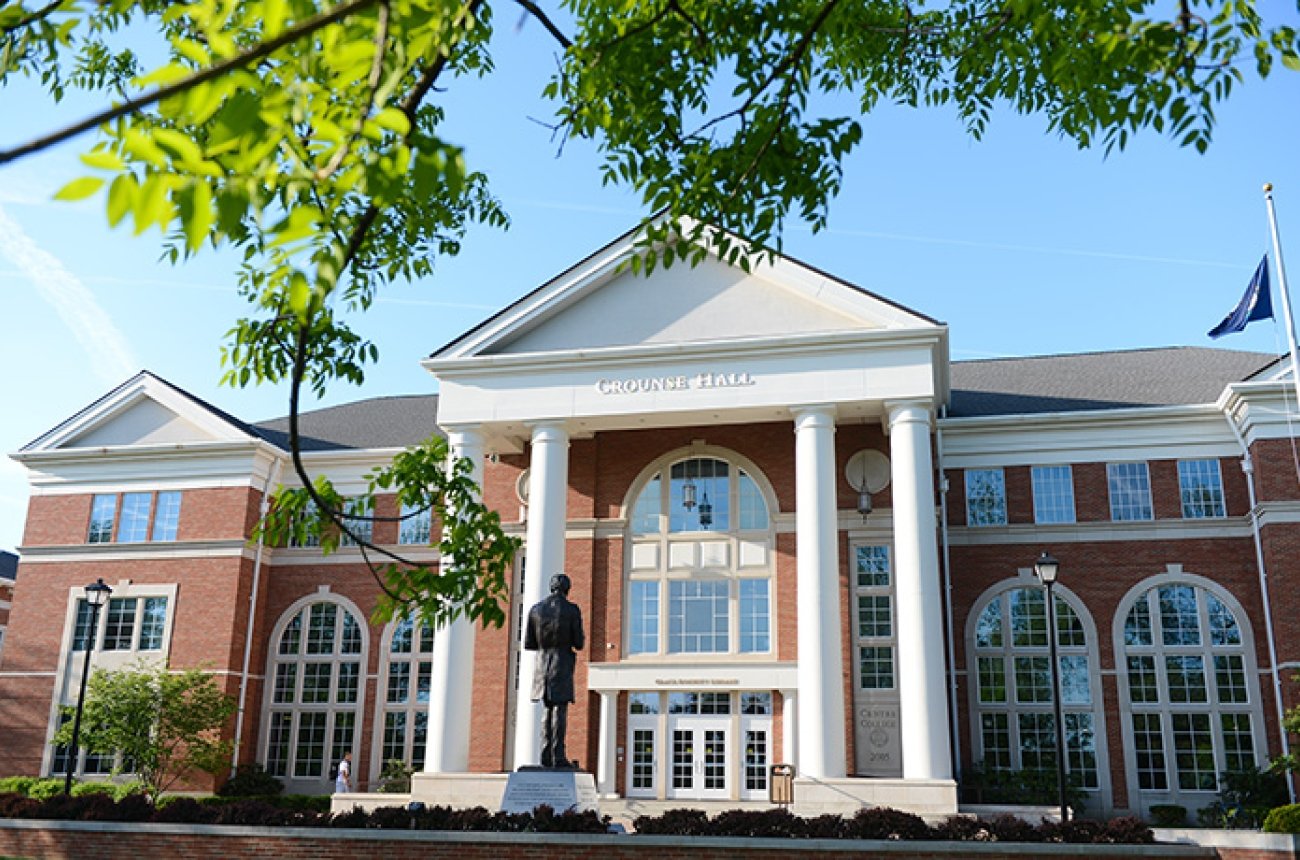 Exterior view of brick double story building with abe lincoln statue facing library