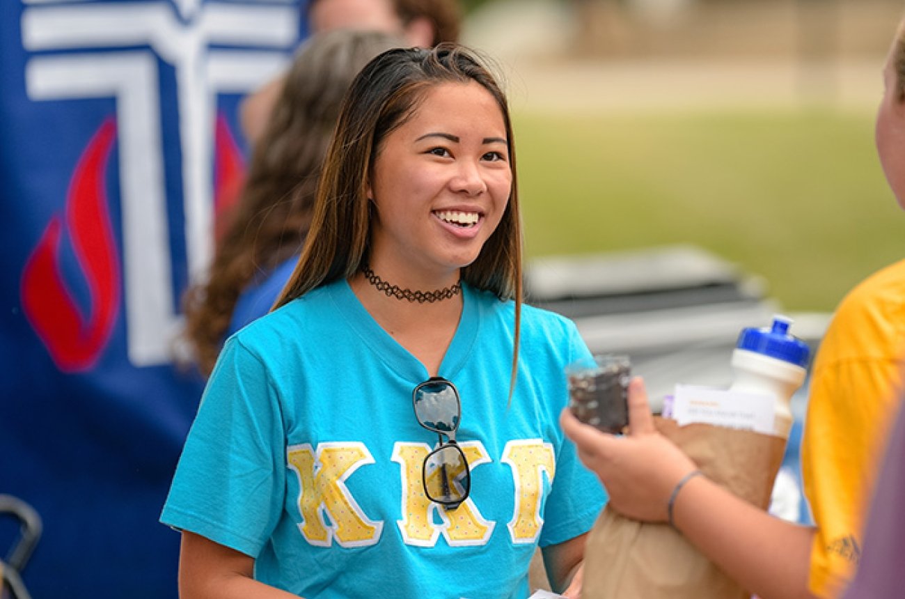 Smiling Centre student wearing a sorority shirt