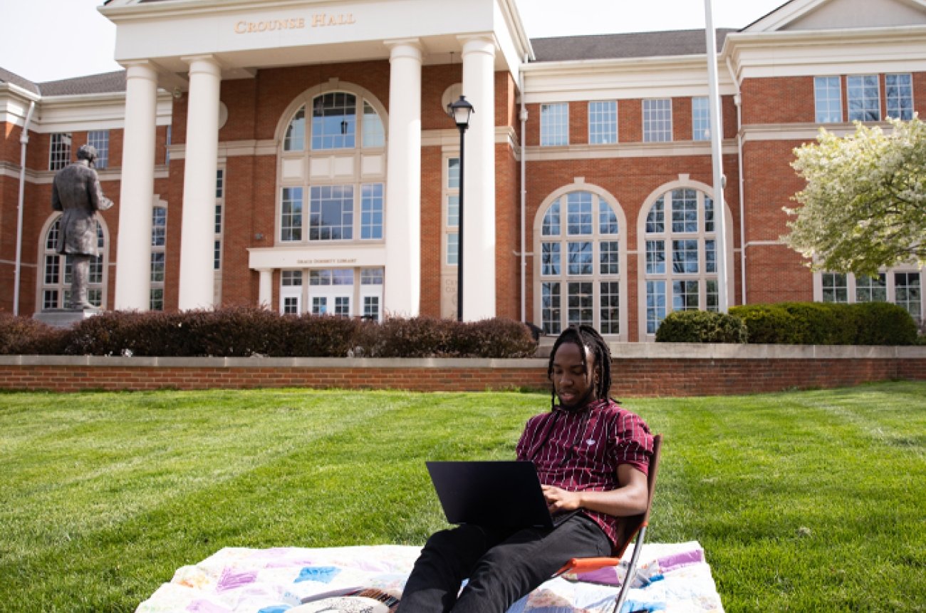 Student studying outside of Crounse Library