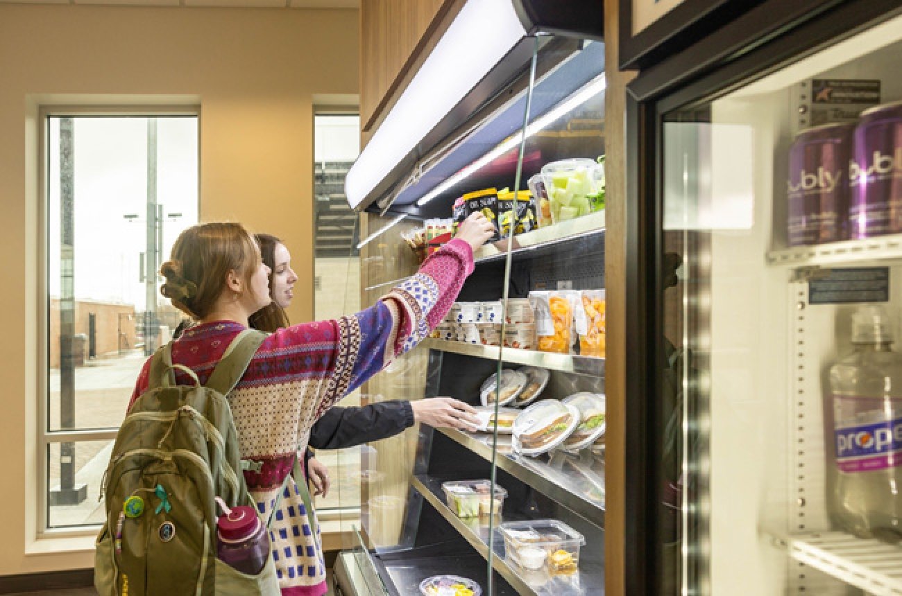 Students picking out food items in the market