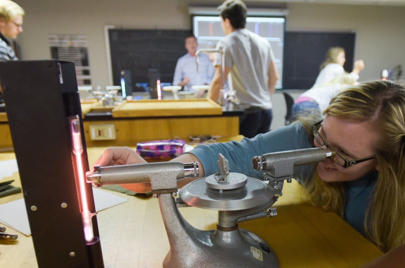 Student participating in a science experiment in a physics lab