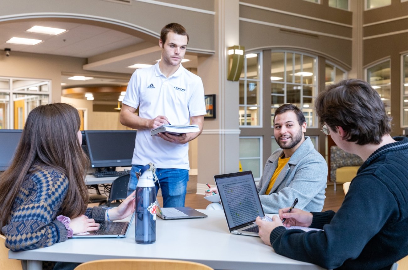 Students sitting around table in library