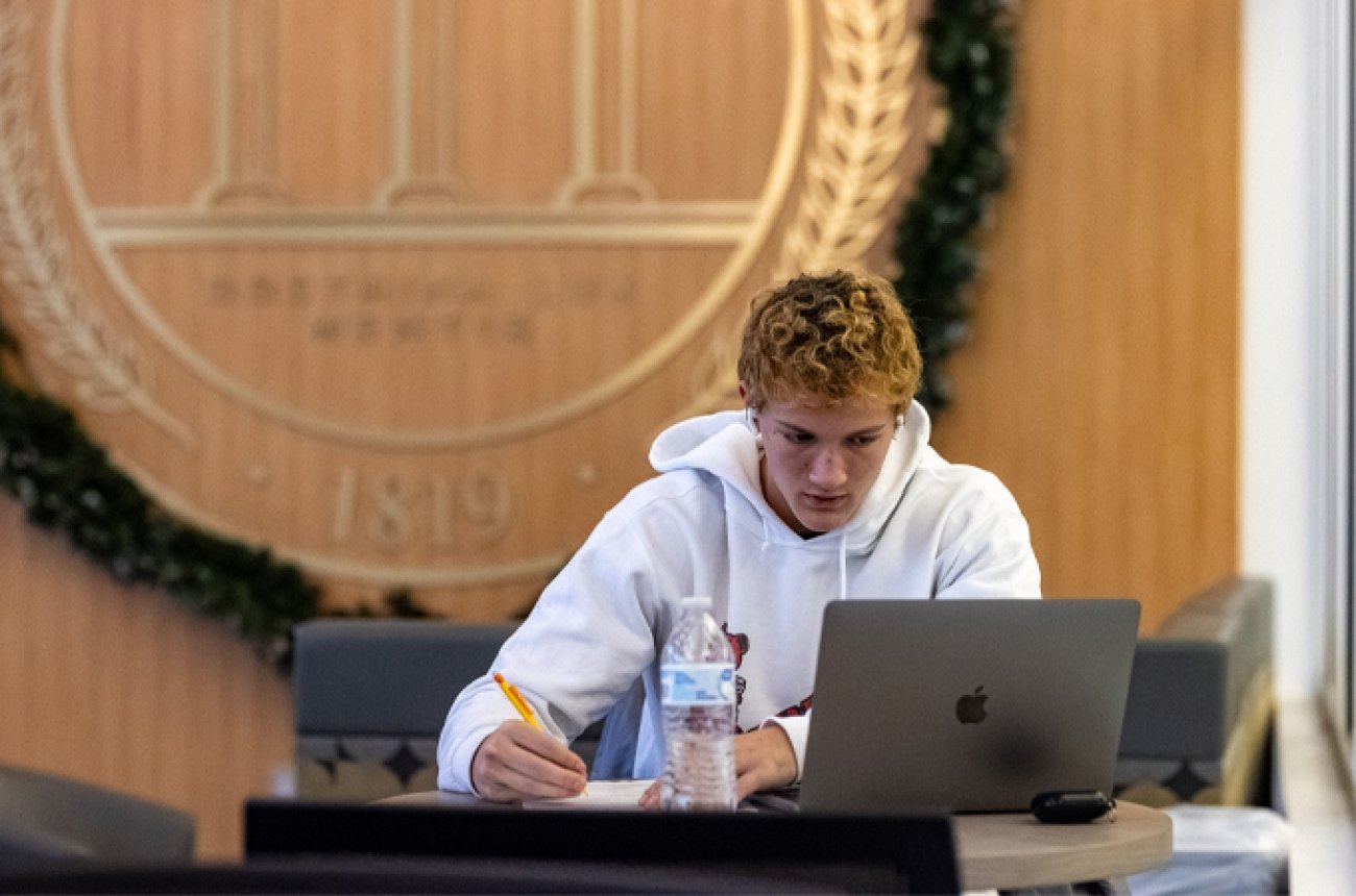 Student studying for finals in the library