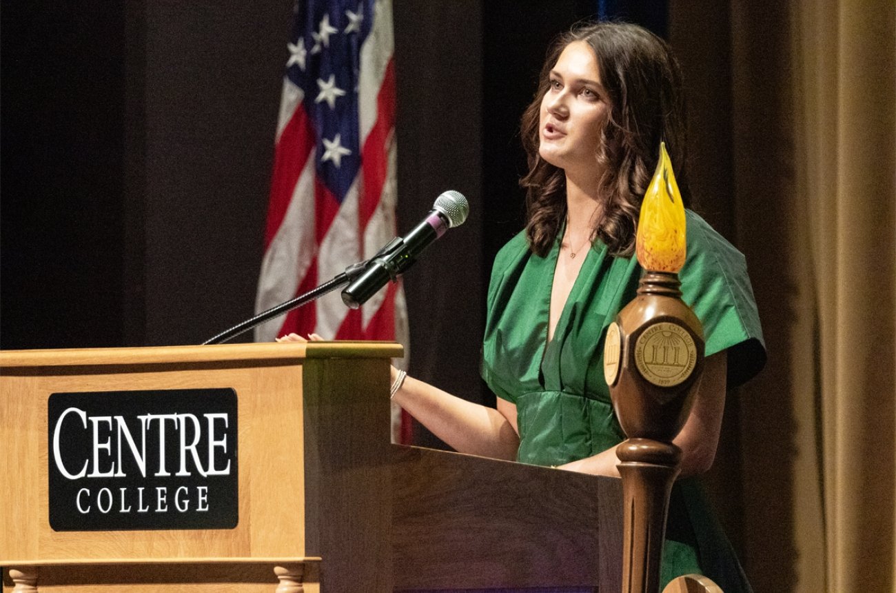 student speaking at convocation at podium