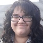 Person wearing glasses and smiling