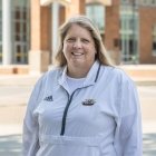 Person wearing Centre College swimming and diving pull over and smiling at camera