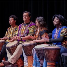 Students playing African drums during a music performance