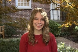 Headshot of Shelby Coffey. She has blonde hair and is wearing a red sweater.