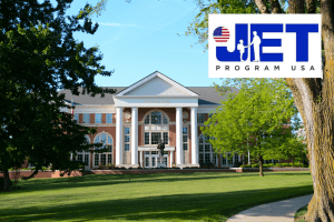 A beautiful photo of Crounse Hall on a spring day with the JET Program USA logo superimposed.