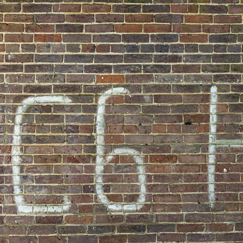 brick wall with white C6H0 painted on the side of building