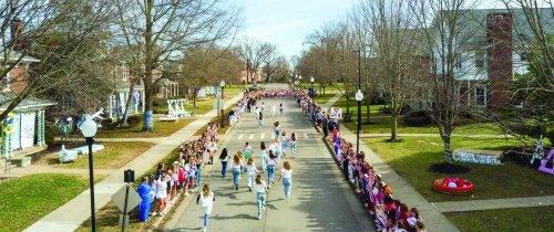 Students running down walnut st on bid day for sororities