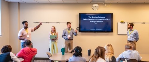 Students presenting at the front of a classroom