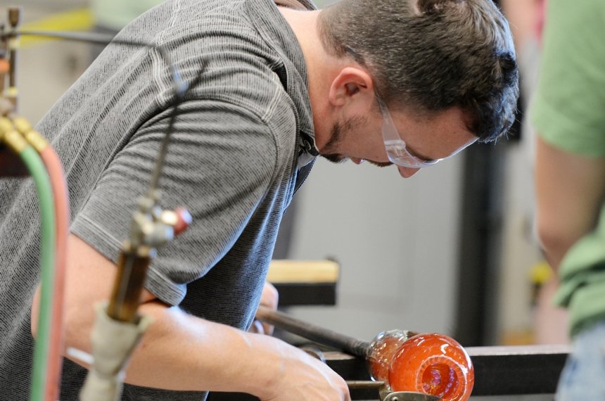 Travis Adams '14 during a hot glass demonstration at Centre Homecoming 2024