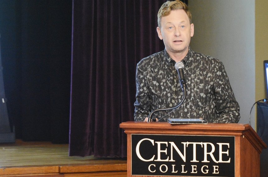 A man speaks from behind a lectern.