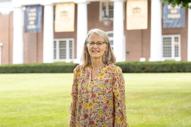 person smiling while standing in front of Old Centre