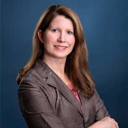 Person wearing dark jacket smiling 