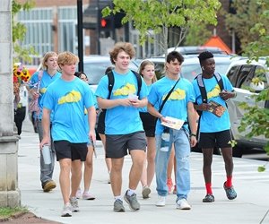 Group of students walking on a sidewalk in downtown Danville