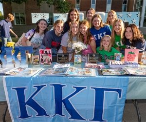 Group of students for a sorority posing for photo during expo
