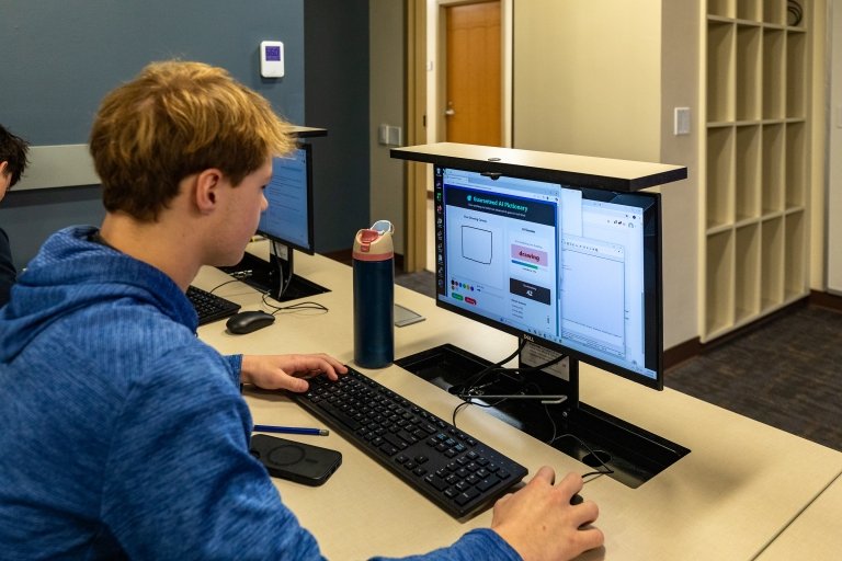 A Centre College student in Professor Thomas Allen's AI class works at a computer. 