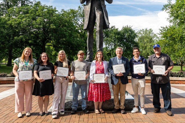 Centre College staff award winners pose with their awards outside the Centre College library