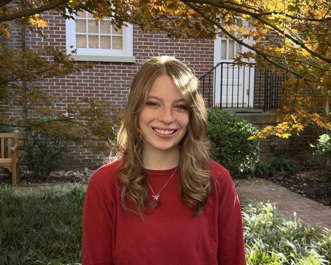 Headshot of Shelby Coffey. She has blonde hair and is wearing a red sweater.