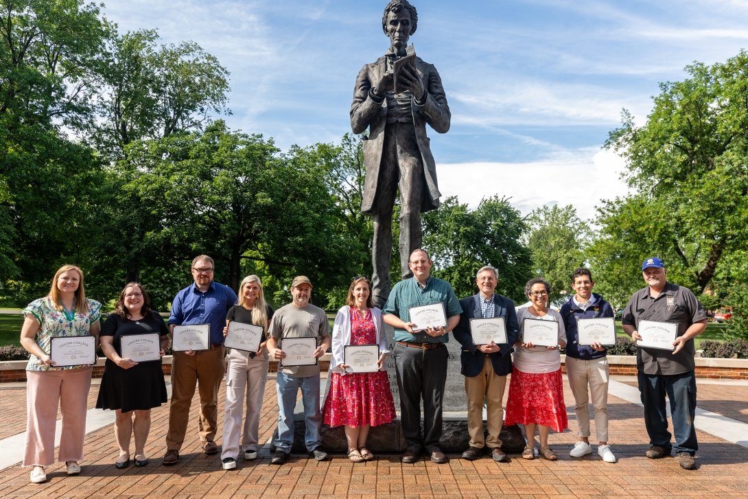 Faculty and staff honored during the end-of-year ceremony pose together outside the Centre College Library.